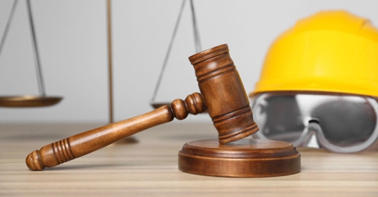 gavel, scales and construction worker's protective gear